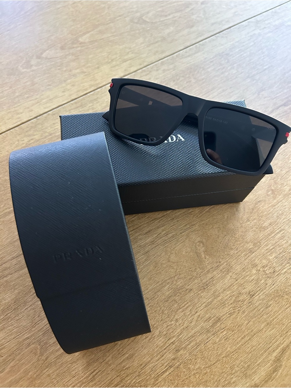 Prada Black Square Sunglasses with Subtle Red Accent